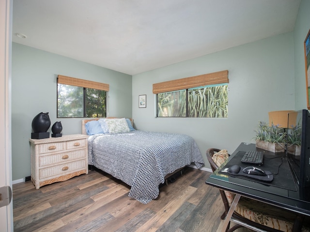 bedroom with dark wood-type flooring