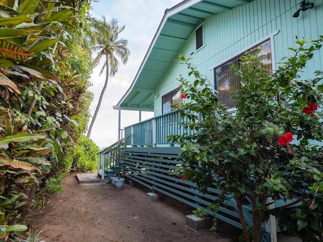 view of property exterior with a wooden deck