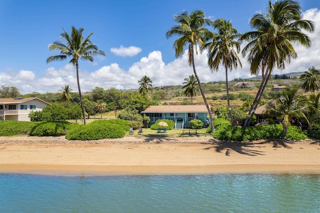 view of swimming pool with a water view and a beach view