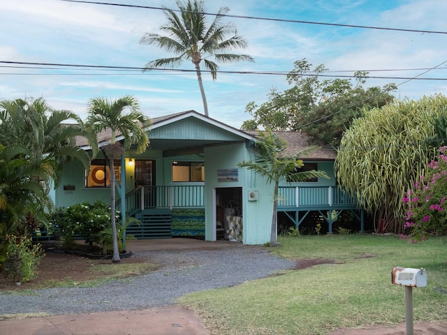 view of front of house with a front yard and covered porch