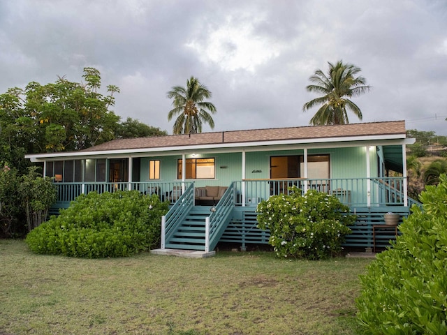 view of front of home with a porch and a front yard