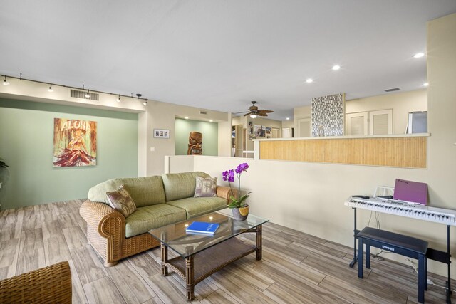 living room with ceiling fan and rail lighting