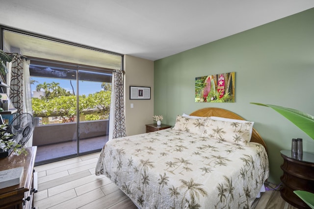 bedroom with light hardwood / wood-style flooring and access to outside