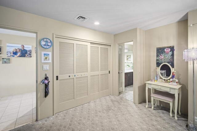 bedroom featuring light colored carpet