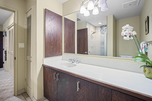 bathroom featuring vanity, toilet, a shower, and tile patterned floors