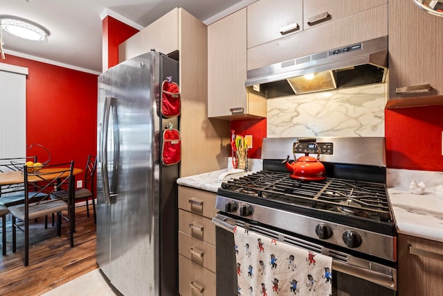 kitchen with decorative backsplash, crown molding, light hardwood / wood-style flooring, and appliances with stainless steel finishes