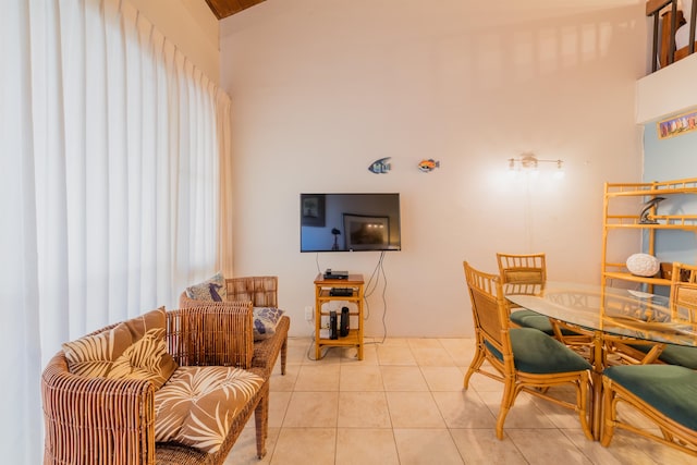 dining room with lofted ceiling and light tile patterned flooring