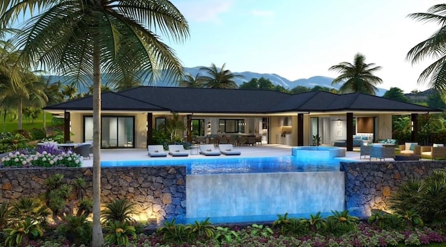 view of swimming pool with a mountain view, an outdoor living space, and a patio area