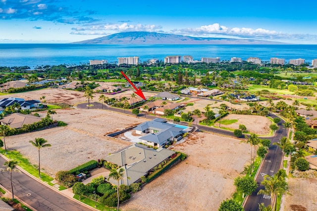 birds eye view of property featuring a water and mountain view