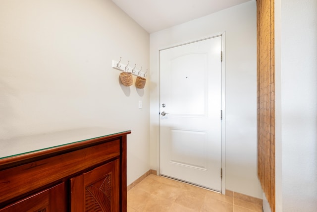 doorway with light tile patterned floors