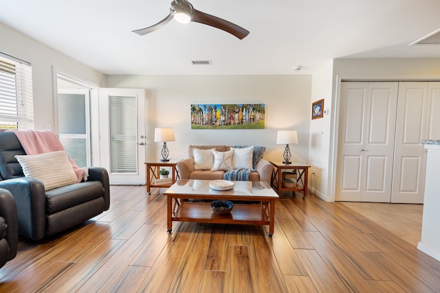 living room featuring ceiling fan and light wood-type flooring