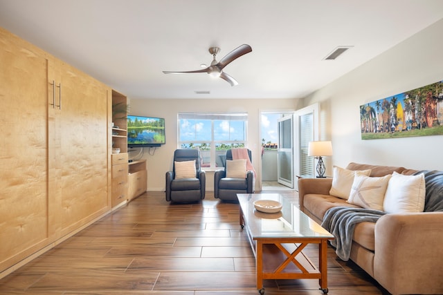 living room with ceiling fan and dark hardwood / wood-style flooring