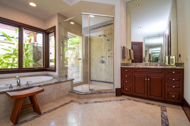 bathroom featuring vanity and shower with separate bathtub