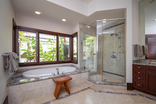 bathroom featuring vanity and shower with separate bathtub