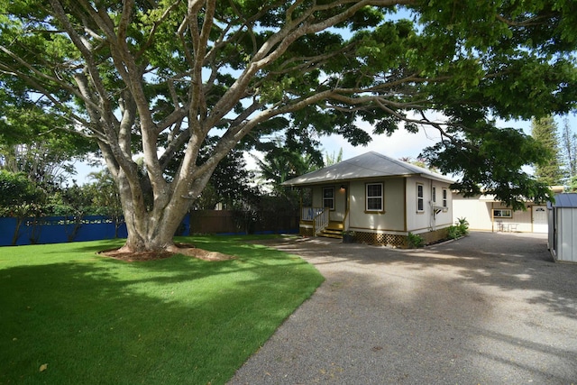 view of front facade with an outbuilding and a front yard