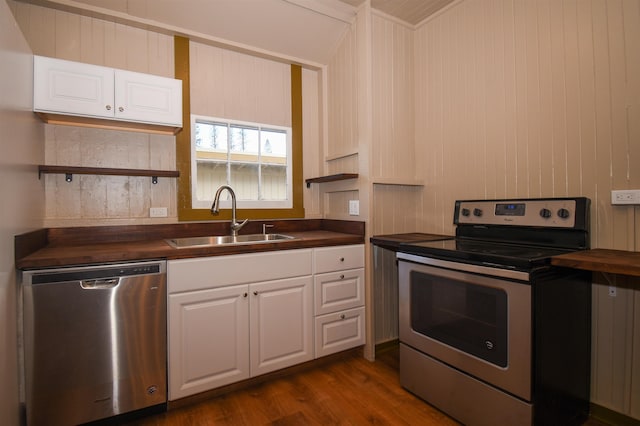 kitchen with sink, wooden counters, dark hardwood / wood-style floors, stainless steel appliances, and white cabinets