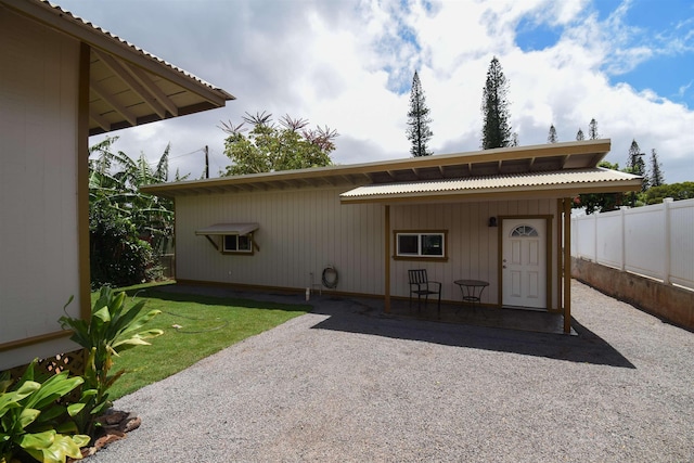 back of property with a patio area and a lawn