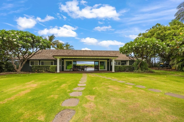 back of house with a lawn