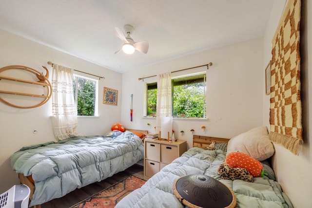 1220 W Kuiaha Rd, Haiku, HI 96708 - bedroom with wood finished floors and ceiling fan