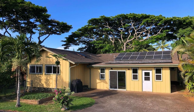 1220 W Kuiaha Rd, Haiku, HI 96708 - rear view of house with roof mounted solar panels and a patio