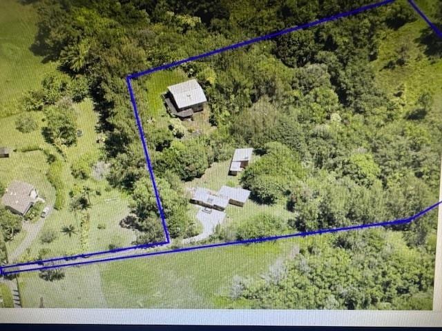 birds eye view of property featuring a wooded view