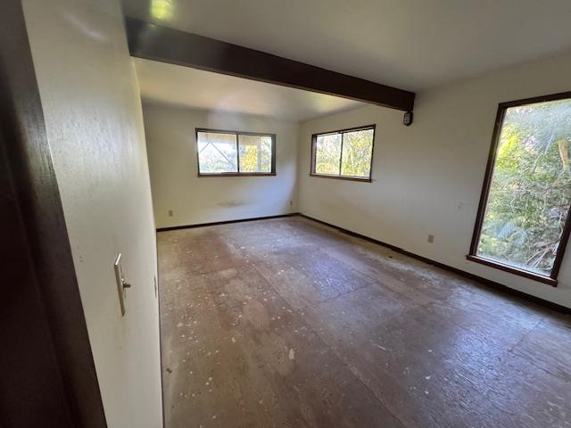 spare room with beamed ceiling