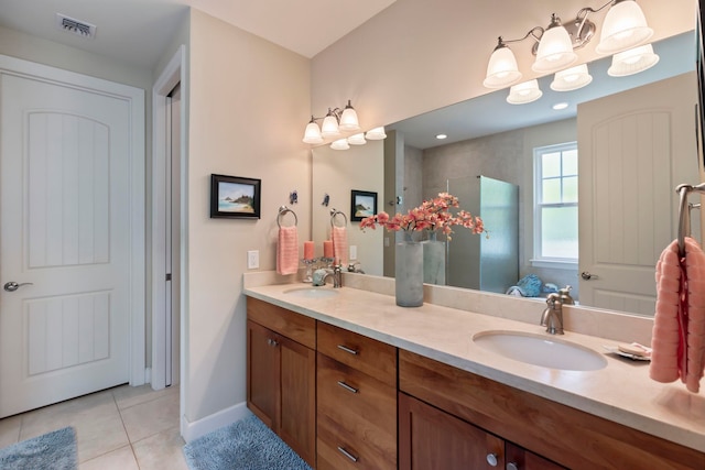 bathroom with a tile shower, tile patterned flooring, and vanity