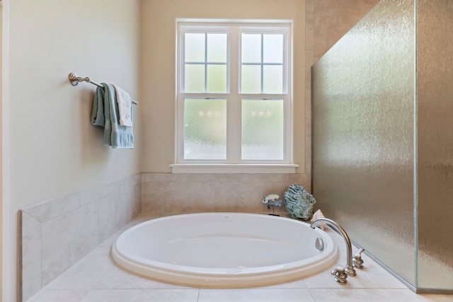 bathroom featuring tiled tub