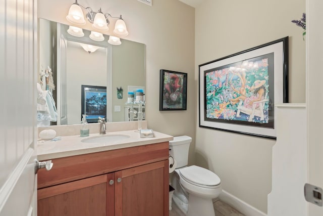 bathroom featuring toilet and vanity