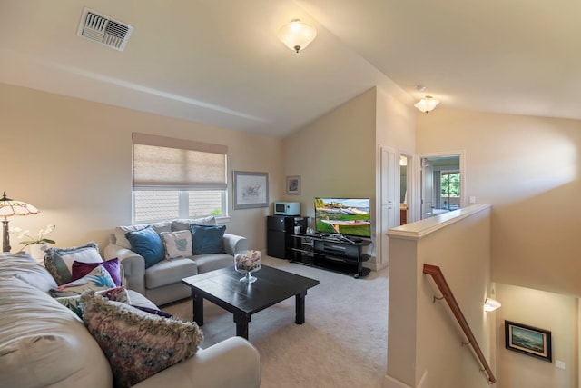 carpeted living room with vaulted ceiling