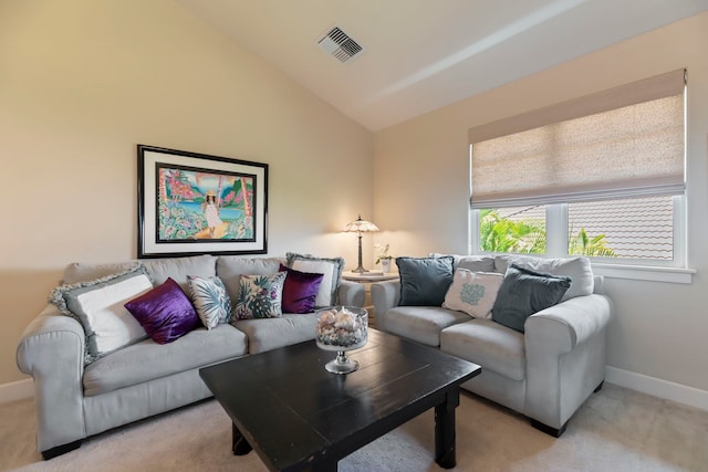 carpeted living room featuring lofted ceiling