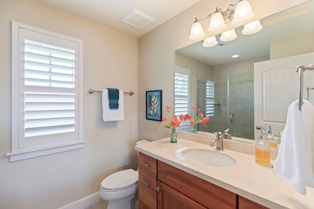 bathroom with vanity, toilet, and walk in shower