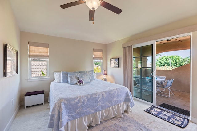 bedroom featuring ceiling fan, access to exterior, light colored carpet, and multiple windows