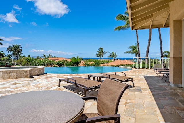 view of pool with an in ground hot tub and a patio area