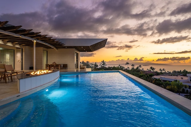14 Halapa Pl, Kihei, HI 96753 - pool at dusk with an outdoor fire pit, an infinity pool, and a patio
