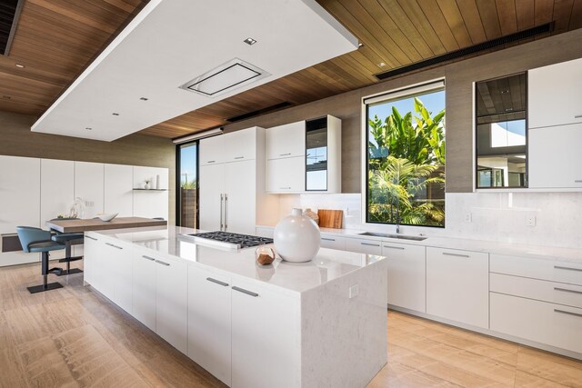 14 Halapa Pl, Kihei, HI 96753 - kitchen with wood ceiling, stainless steel gas cooktop, modern cabinets, a kitchen island, and white cabinetry