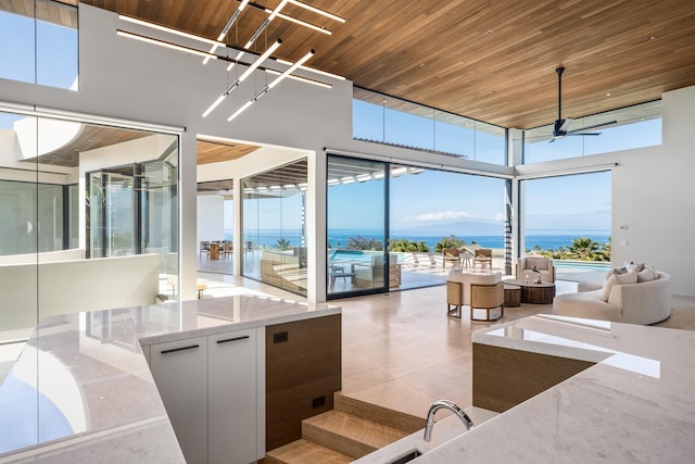 14 Halapa Pl, Kihei, HI 96753 - kitchen with wooden ceiling, light stone countertops, a wall of windows, a high ceiling, and open floor plan