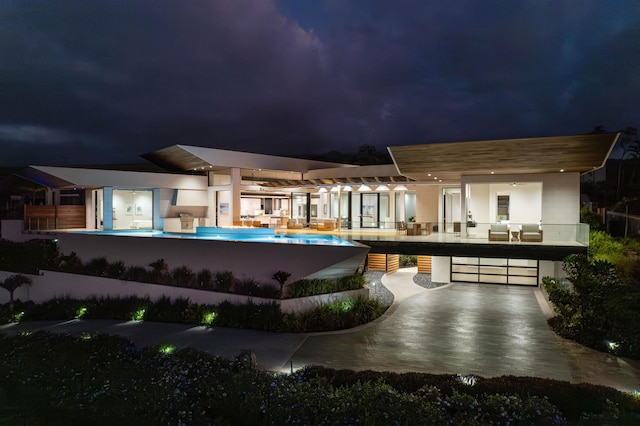 14 Halapa Pl, Kihei, HI 96753 - back of house at twilight featuring an infinity pool