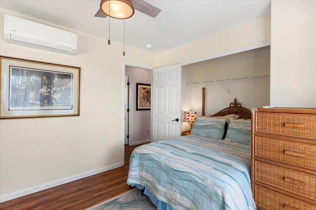 bedroom with a closet, a wall unit AC, ceiling fan, and dark wood-type flooring