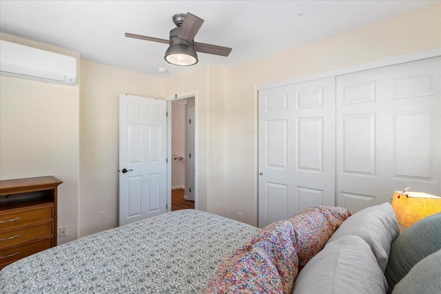 bedroom featuring a wall mounted air conditioner, ceiling fan, and a closet