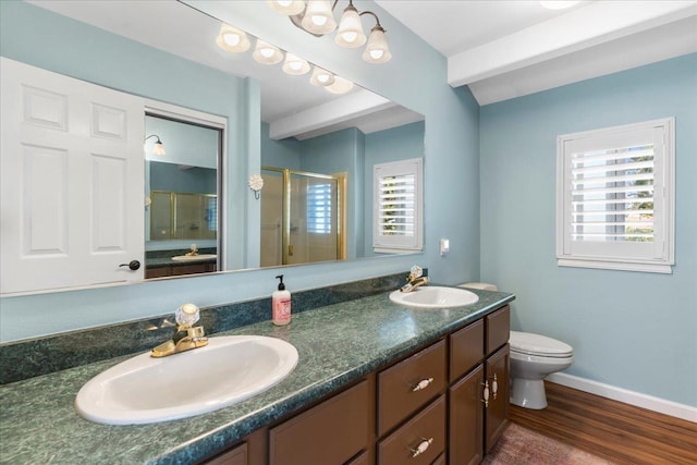 bathroom with wood-type flooring, toilet, plenty of natural light, and a shower with shower door