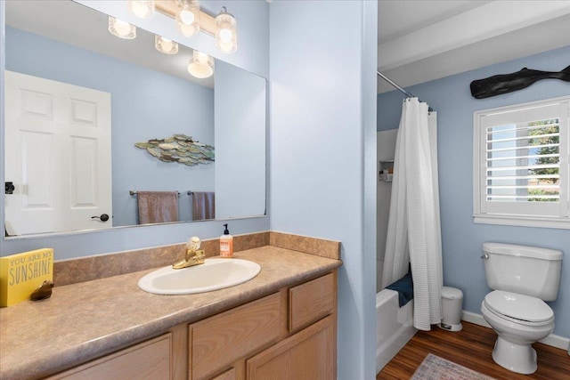 full bathroom featuring hardwood / wood-style floors, vanity, toilet, and shower / tub combo with curtain