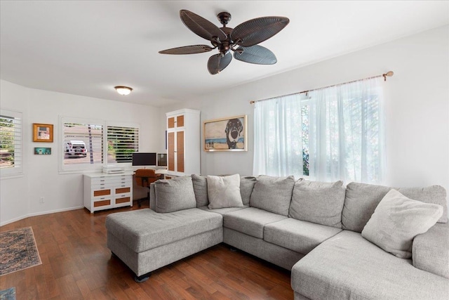 living room with ceiling fan and dark hardwood / wood-style flooring