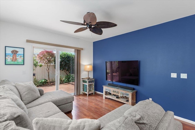 living room featuring hardwood / wood-style flooring and ceiling fan