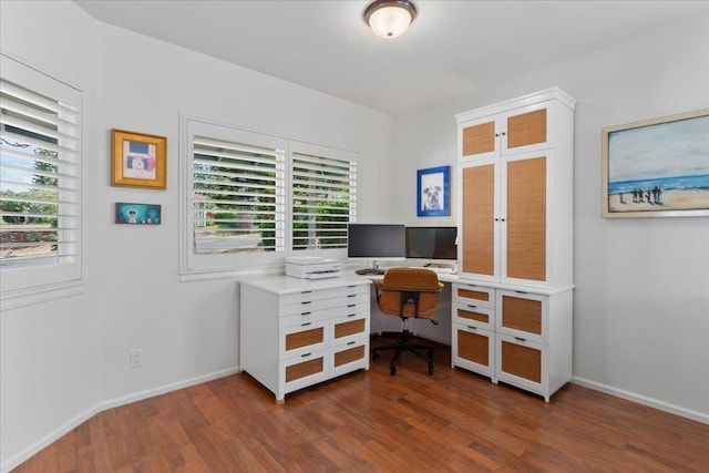 office area with plenty of natural light and dark wood-type flooring