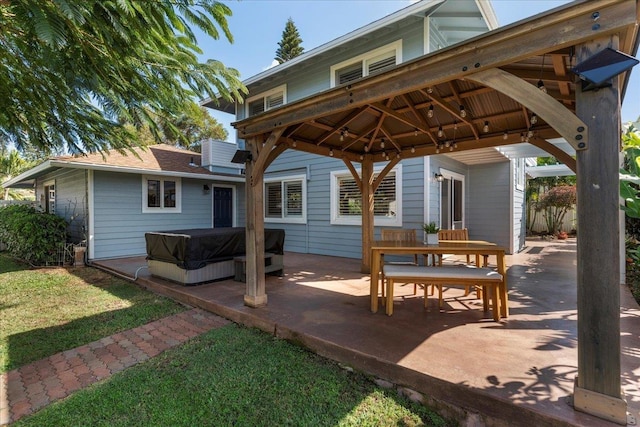 view of patio / terrace featuring a gazebo and a hot tub