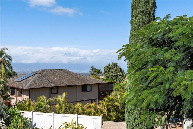 view of side of home with solar panels