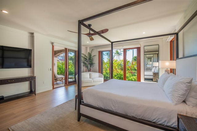 bedroom with access to exterior, multiple windows, ceiling fan, and light wood-type flooring