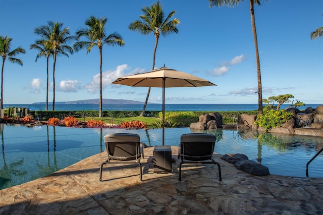 view of patio featuring a water and mountain view