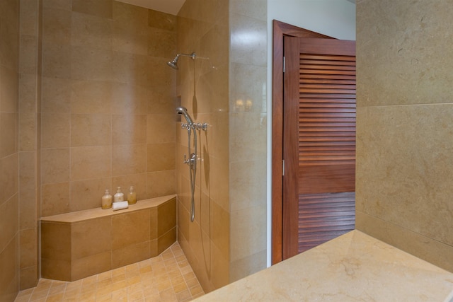 bathroom featuring tiled shower and tile walls